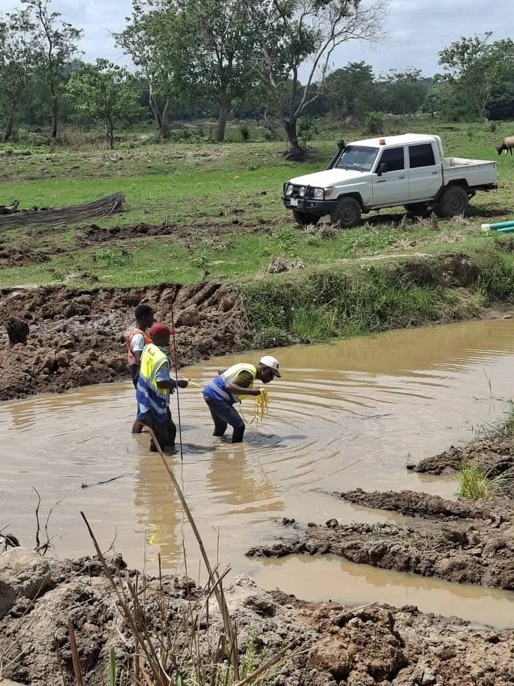 Crew surveying a flooded river crossing