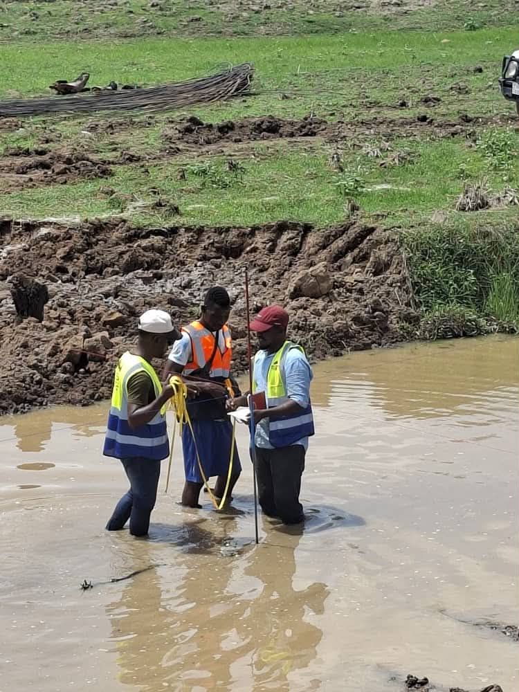 Survey team taking measurements in water
